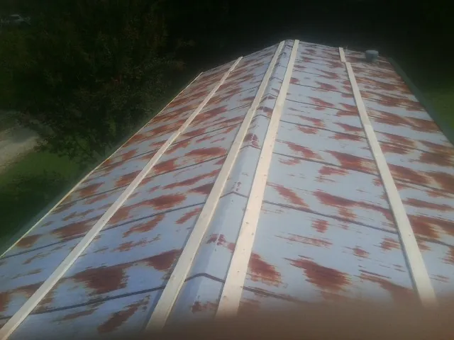 Rusted metal roof panels with new wood purlins before replacement — Storm Damage Roof Repair in Church Road by Roofing Brothers