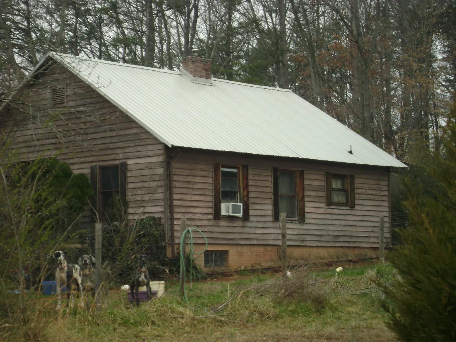 White metal roof on an old wood sided farmhouse, from a Metal Roof Installation job in Church Road